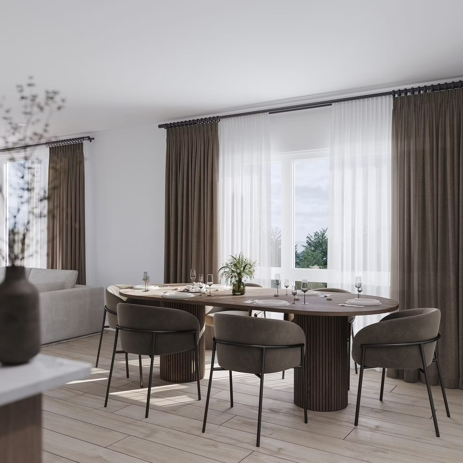 West Windsor suite dining area with an oval table beside full-height windows